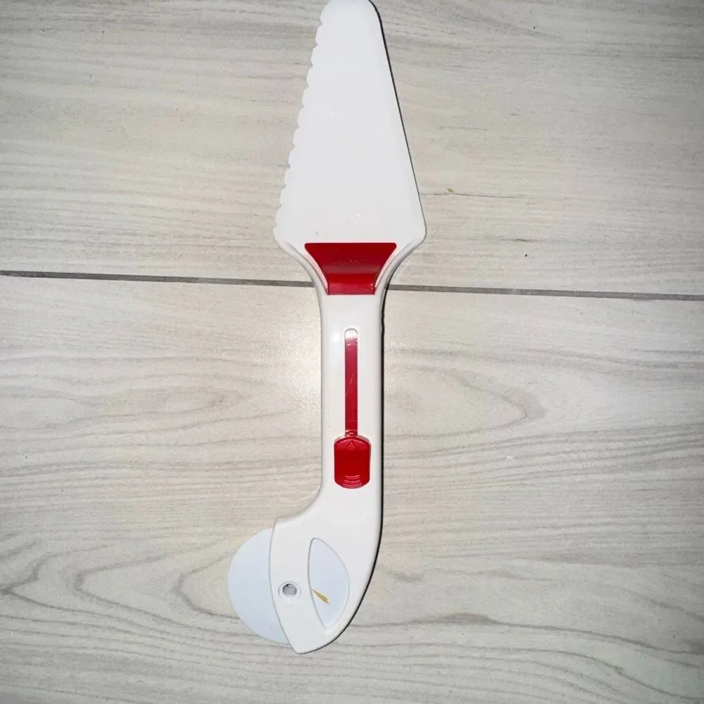 Vintage pizza cutter, cake cutter. Has a switch to push slice off and can be tak